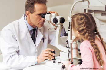 A doctor examines a child's eyes
